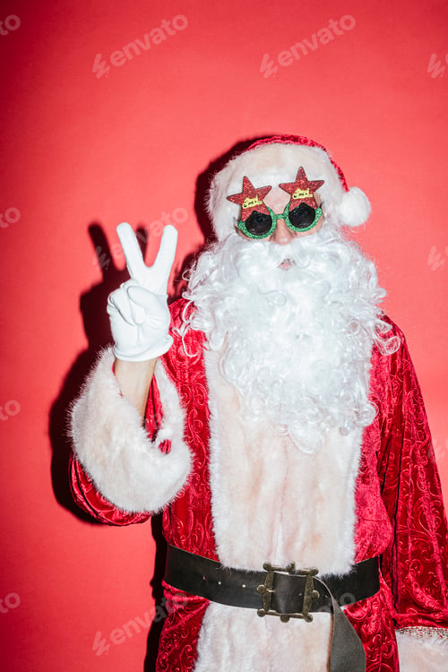 Preview: Man dressed as Santa Claus gesturing with funny glasses