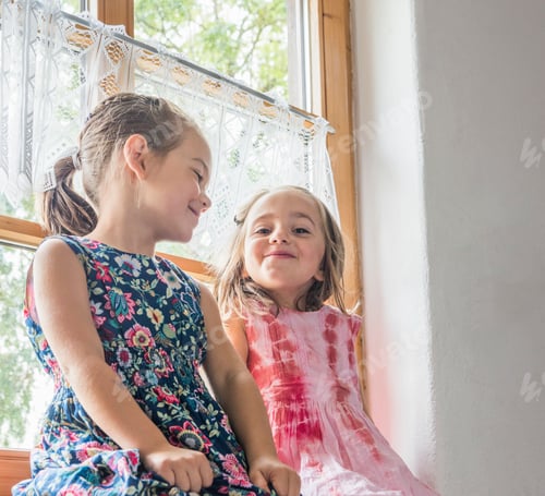 Preview: Girl sitting on windowsill smiling