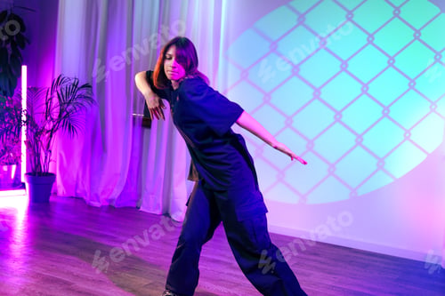 Preview: Dance performance showcases expressive movement under colorful lights in a modern venue