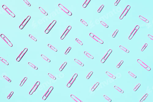 Preview: Colored paper clips on pastel blue background. Top view, flat lay. Back to school concept. College