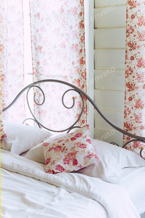 Preview: Bright bedroom interior with flower pattern pillows on bed