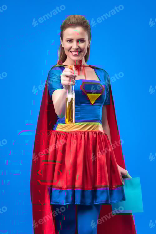 Preview: smiling woman in superhero costume with rag and detergent in hands isolated on blue