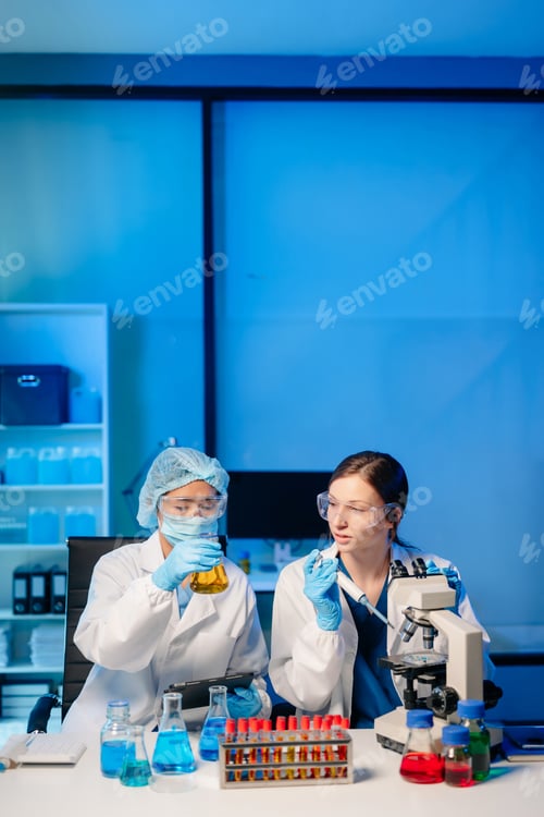 Preview: Modern Medical Research Laboratory Portrait of Two Scientists Working, Using Digital Tablet,