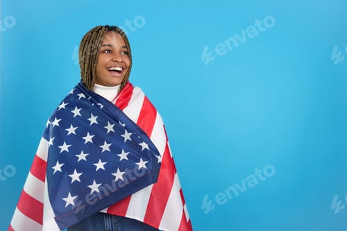 Preview: African woman looking aside wrapped in a North American flag
