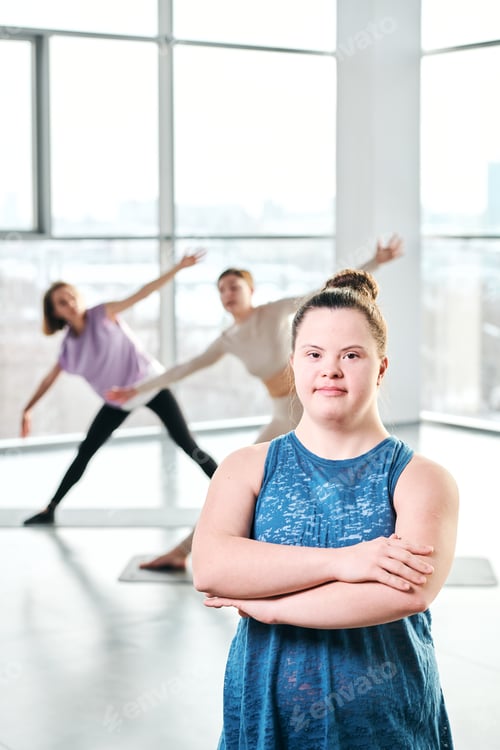 Preview: Young active disable female in blue t-shirt crossing arms by chest