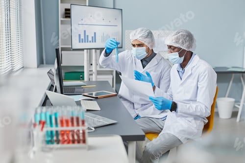 Preview: Men examining samples in tubes