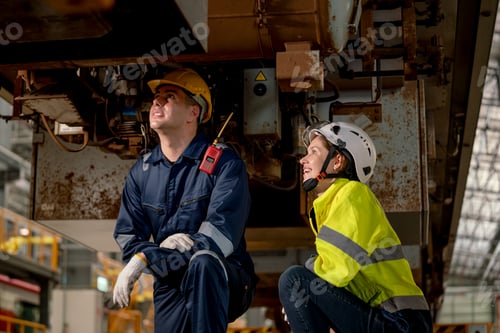 Preview: Technician man and train factory worker woman check and fix the problem and stay under train