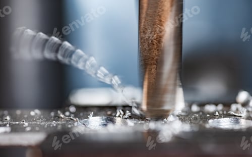 Preview: Drilling process with shavings close-up at the workplace in workshop