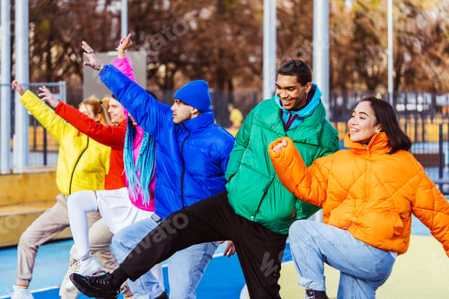 Preview: Multiracial group of young friends meeting outdoors in winter