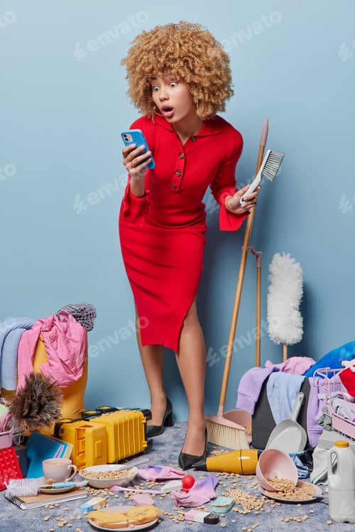 Preview: Woman in bustling room armed with phone and cleaning supplies deftly navigates chaos effortlessly