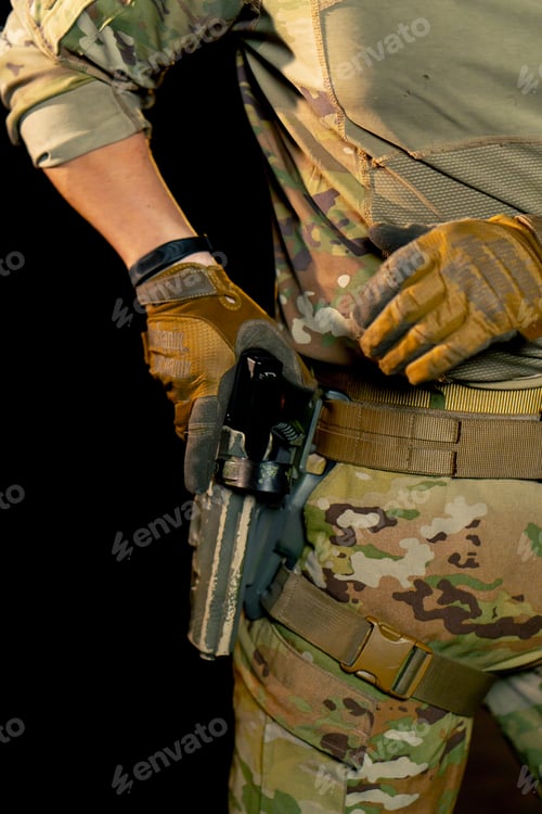 Preview: close-up at a professional shooting range military weapons trainer standing preparing to use a