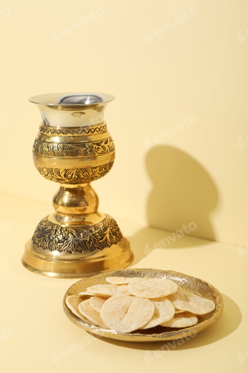 Preview: Liturgical bread and cup on light yellow background