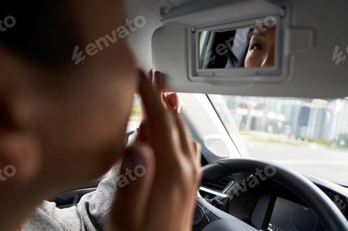 Preview: Close up of Chinese car driver looking at the mirror reflection