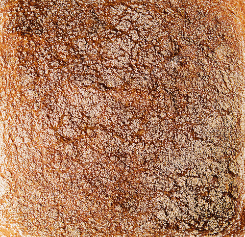 Preview: Black bread closeup on white with slice