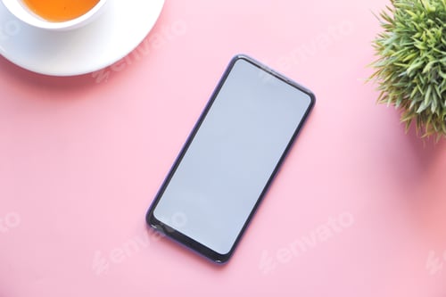 Preview: top view of smart phone with white screen on pink background