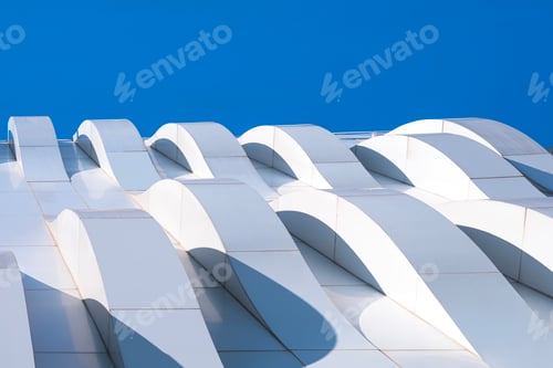 Preview: Curve Pattern of Geometric White Aluminum Composite Tile Wall against Blue Sky Background