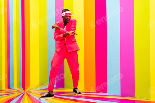 Preview: Beautiful young woman dancing and having fun inside a rainbow box room
