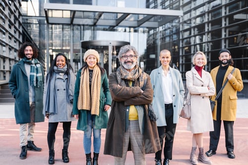 Preview: Senior boss standing together with business people group in the corporate financial district