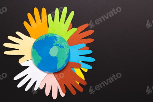 Preview: Paper cut out of multi coloured hands and globe with copy space on black background