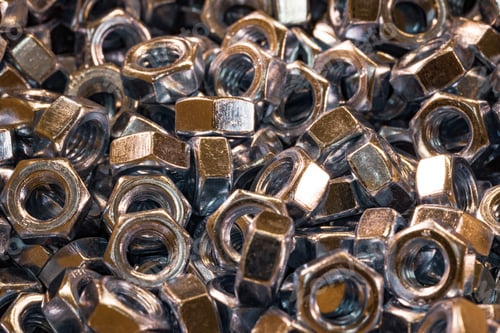 Preview: Metal chrome nuts in a chaotic order industrial background