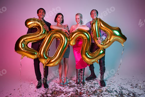 Preview: New Year party, joyful interracial friends in festive attire holding balloons with 2024 numbers
