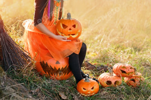 Preview: A girl in an orange dress holds a pumpkin with an evil smile carved