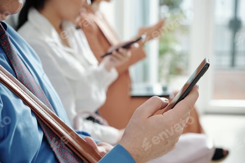 Preview: Mature businessman checking phone