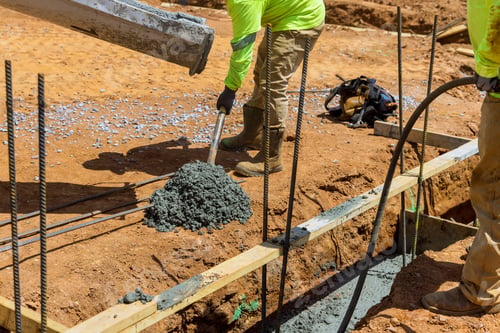 Preview: Worker pouring concrete foundation for new house on construction site