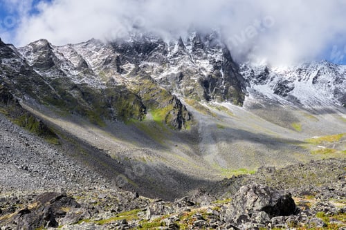 Preview: View of mountain peak covered with clouds