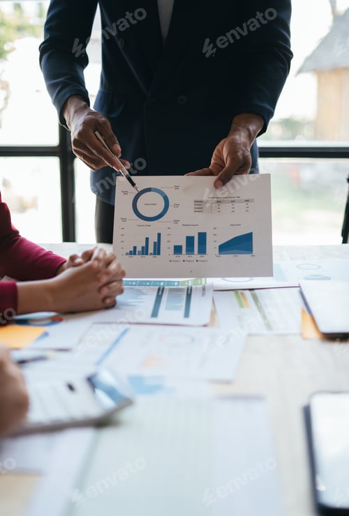 Preview: Business Team Reviewing Charts in an Office