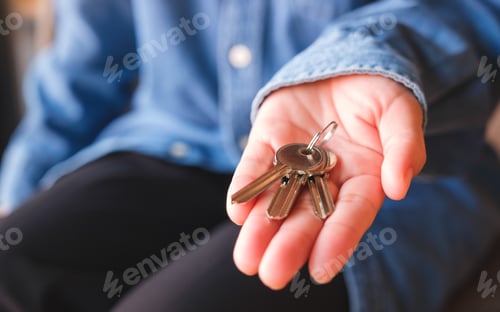 Preview: Closeup image of a hand holding the keys for real estate concept
