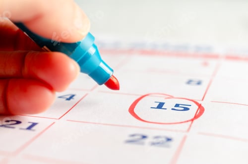 Preview: Person marking a date on a calendar.