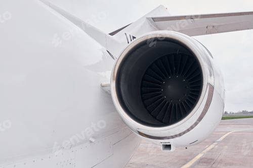 Preview: Close up view. Turboprop aircraft parked on the runway at daytime