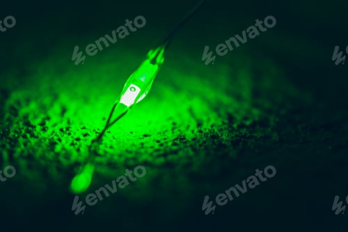 Preview: Garland with green light elements in the dark close up