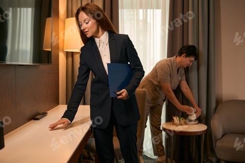 Preview: Housekeeping manager supervising maid performance during room cleaning procedure