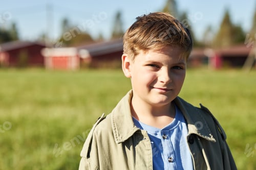 Preview: Portrait of Caucasian Boy Smiling Outdoors in Sunlight on Summer Day