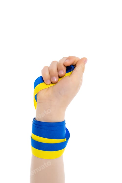 Preview: partial view of kid holding blue and yellow ribbon isolated on white