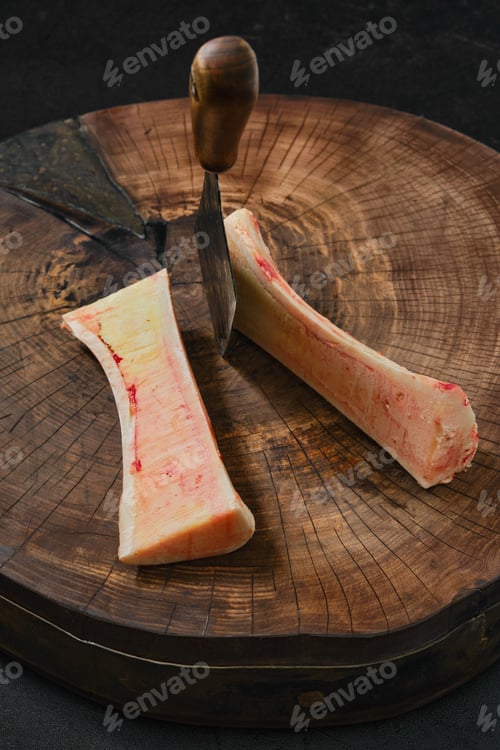 Preview: Top view of large beef bone marrow chopped with cleaver on half