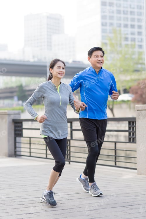 Preview: Happy mature couple running in park