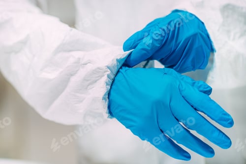 Preview: Putting on Blue Gloves Wearing White Protective Suit