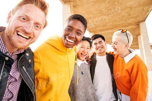 Preview: Portrait of multiracial group of friends hugging and looking camera. Smiling people having fun