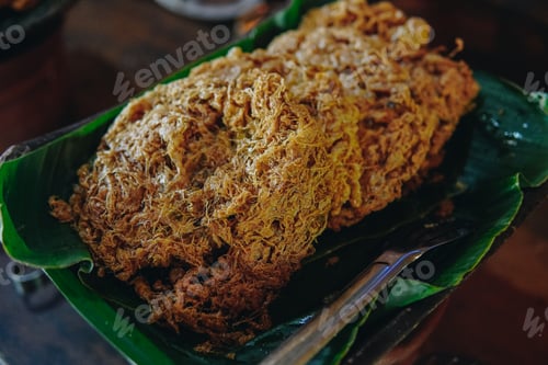 Preview: A plate of Indonesian fried omelette named Telur Kribo on top of banana leaf.