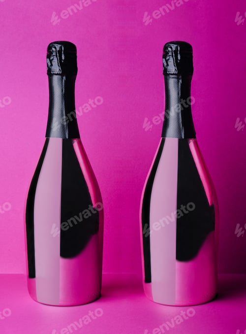 Preview: two champagne bottles on pink background