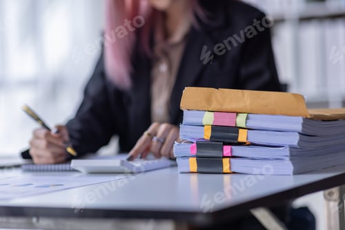 Preview: Business Asian woman Using laptop computer and working at office with calculator document on desk,