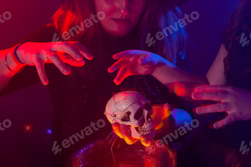 Preview: Two halloween witches making magic in halloween night. Magic, holidays and mystic concept.