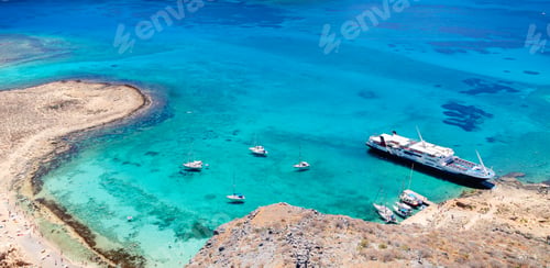 Preview: Sailboats anchored near a stunning turquoise beach