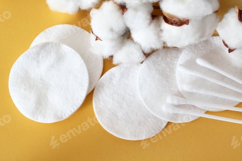 Preview: Cotton Puffs, Swabs, and Bolls on Yellow Background Gentle Skincare and Hygiene Essentials.
