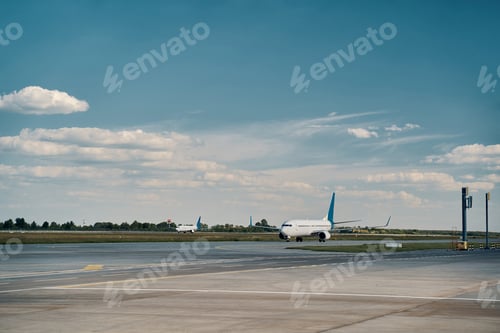 Preview: Civil airplanes parked on the runway in the morning