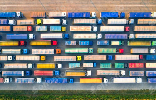 Preview: Aerial view of colorful trucks in terminal at sunset in summer