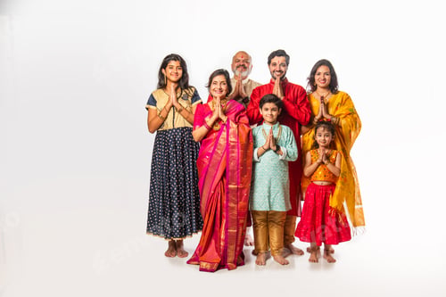 Preview: Indian family in festive mood, welcoming guests with Namaste while looking at the camera
